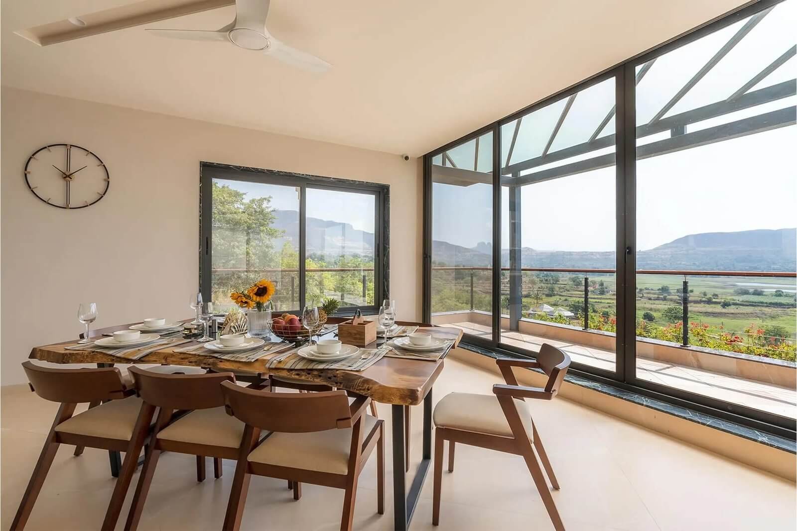 DINING TABLE – Set for dinner, warm evening light, candles.